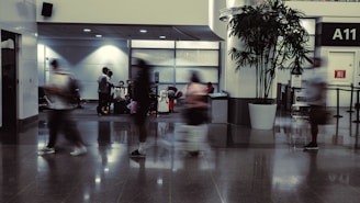 a group of people walking through an airport lobby