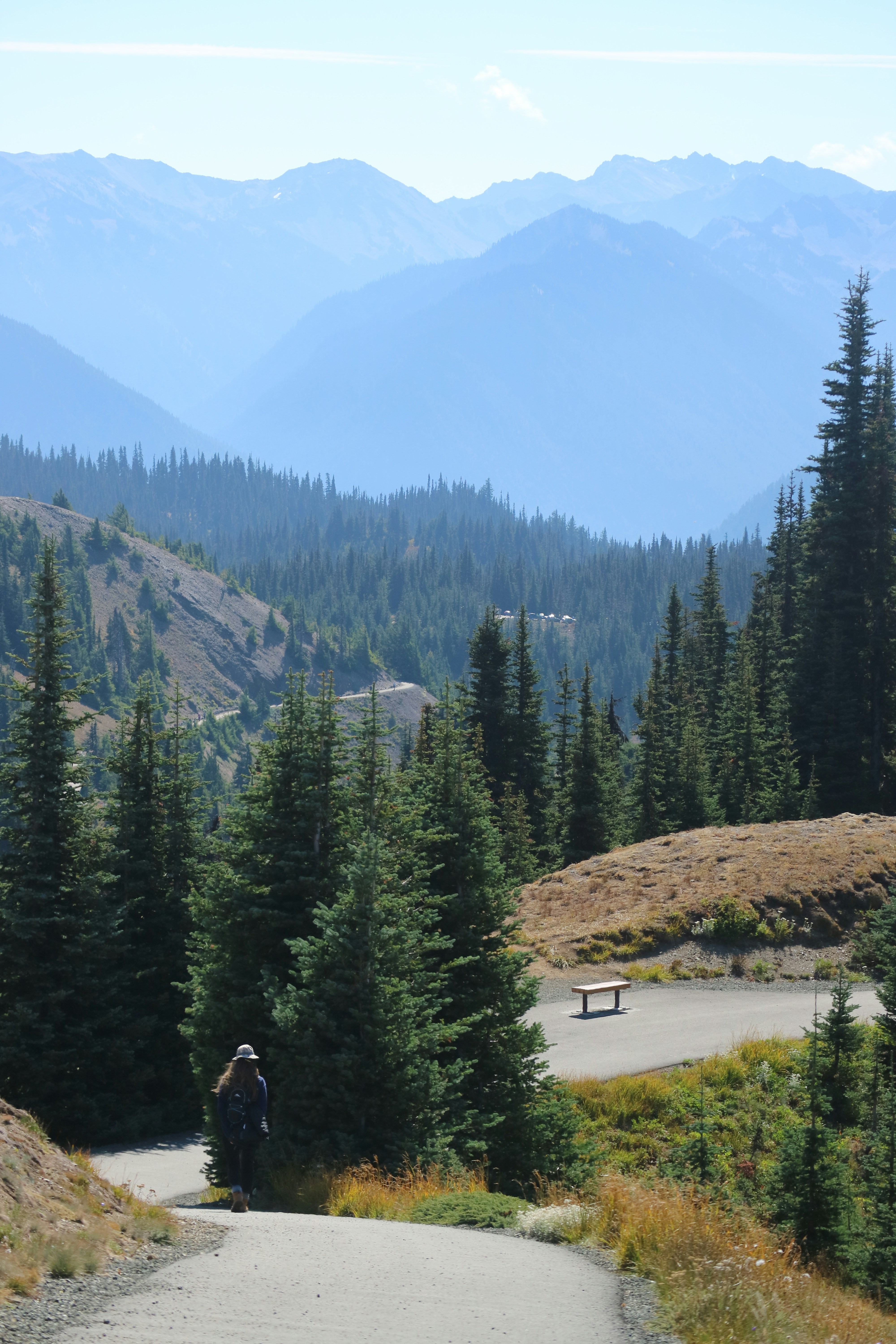 a man riding a skateboard down a dirt road