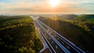 an aerial view of a highway surrounded by trees