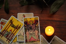 a candle sitting next to a set of tarot cards