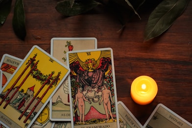 ace of wands, four of wand, and the lovers tarot cards placed on a table