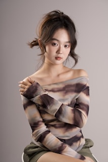 A stylish off-shoulder top showcased against a neutral backdrop.