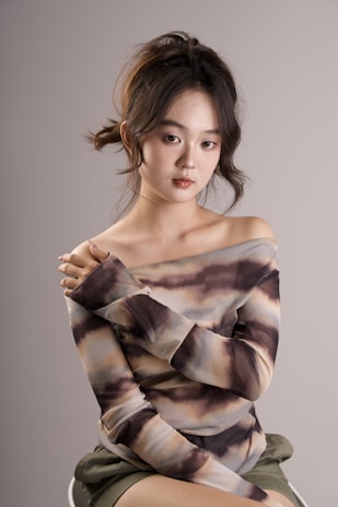 A stylish off-shoulder top showcased against a neutral backdrop.