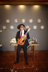 Ukulele player entertaining guests with joyful rhythms at a wedding.