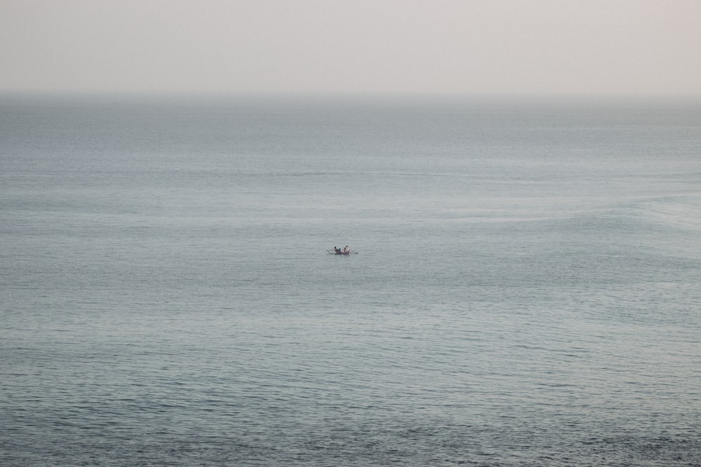 a lone boat in the middle of the ocean