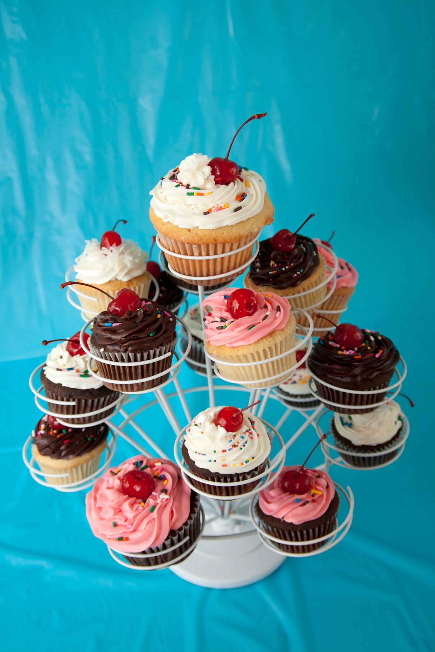 Wedding cake alternatives for small budgets — A pegboard donut wall decorated with fresh flowers at a backyard wedding.