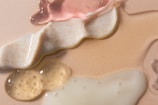 three different types of soap on a pink surface