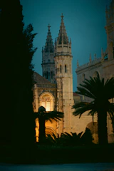 A vast cathedral spire piercing a twilight sky, its stained glass windows glowing faintly.