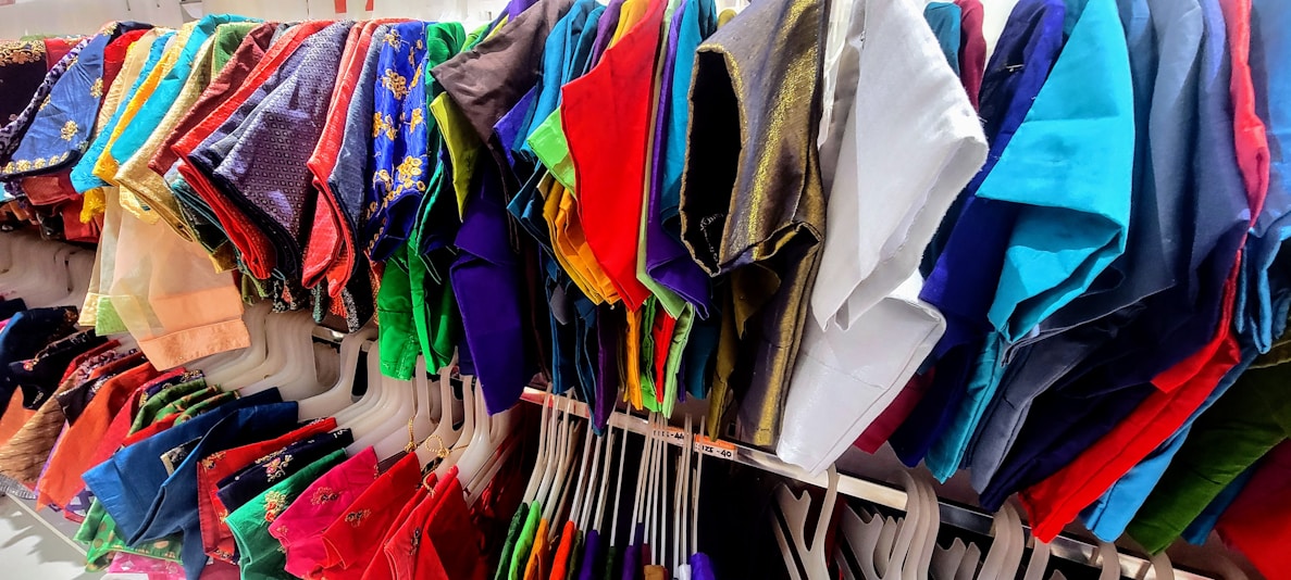 A vibrant display of assorted clothing items on hangers.