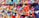 Rows of neatly arranged colorful fabric rolls fill the shelves with a wide range of patterns and textures. The fabrics are tightly packed, displaying a rich array of colors including reds, blues, greens, yellows, and purples. Each roll appears unique, contributing to a vibrant, visually appealing tapestry.