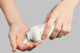 A close-up of hands holding a pill bottle with the Polaris Capital logo visible.
