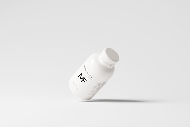 A simplistic and modern design featuring a medicine bottle floating against a light grey background, with minimalistic labeling and a clean appearance.
