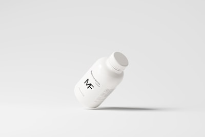 A simplistic and modern design featuring a medicine bottle floating against a light grey background, with minimalistic labeling and a clean appearance.