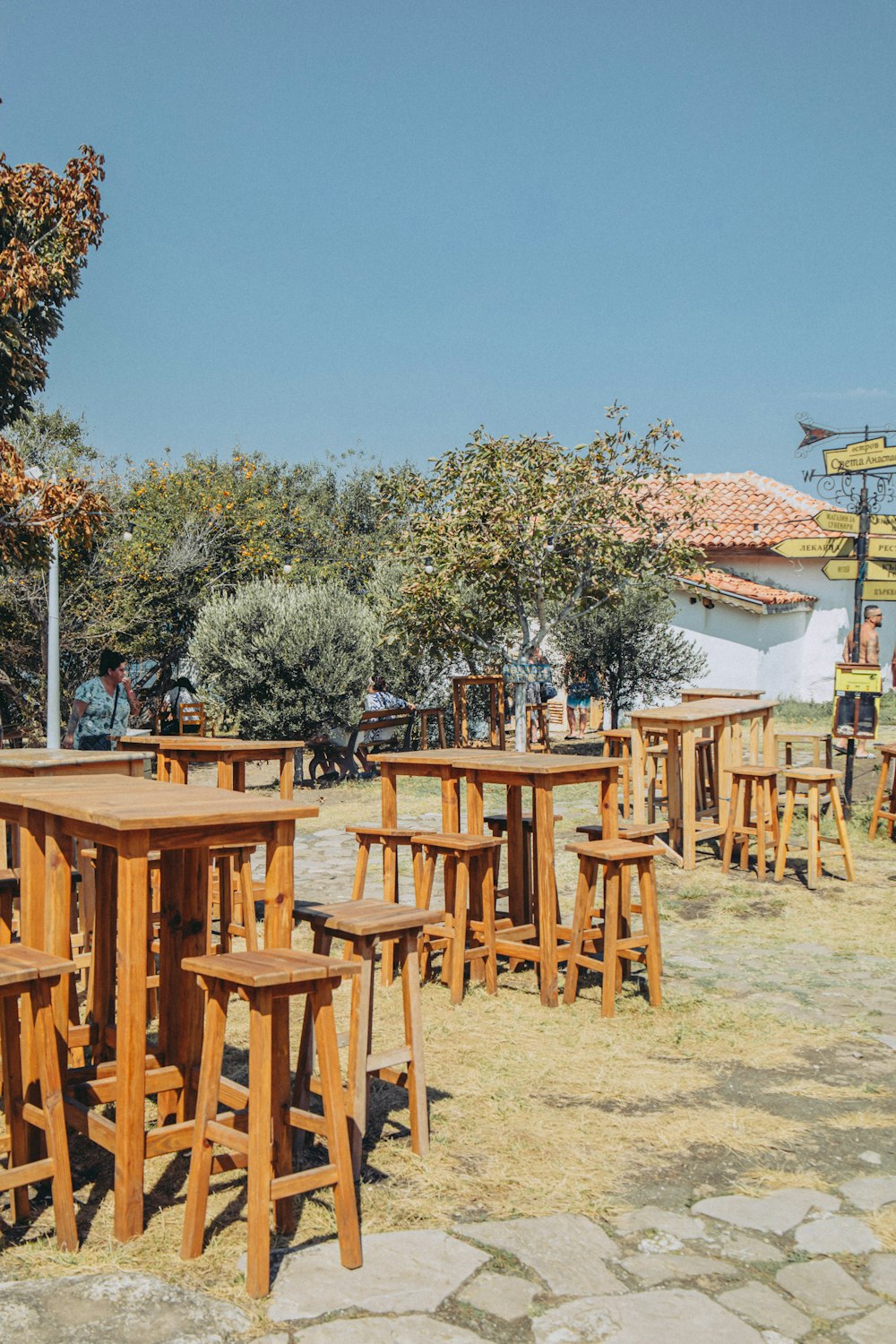 a number of wooden tables and chairs near one another