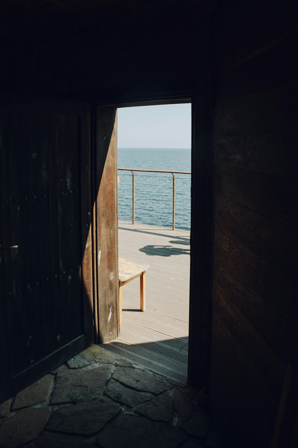 an open door with a bench in the middle of it