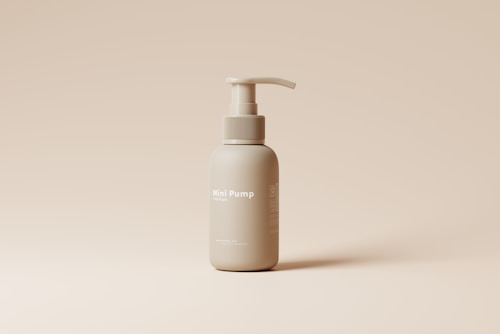 A beige liquid pump bottle is centered on a similar-colored background. The bottle is labeled 'Mini Pump mockup' and features a simple, minimalist design.