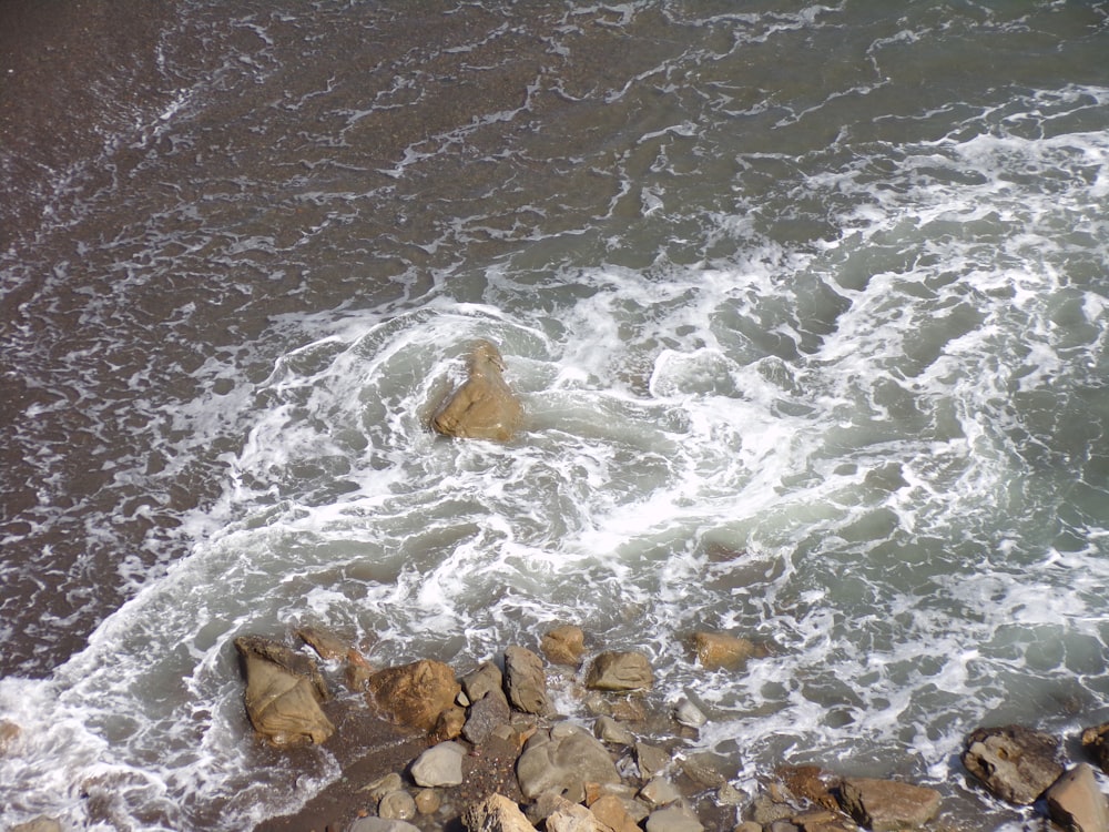 a view of a body of water with rocks in the foreground