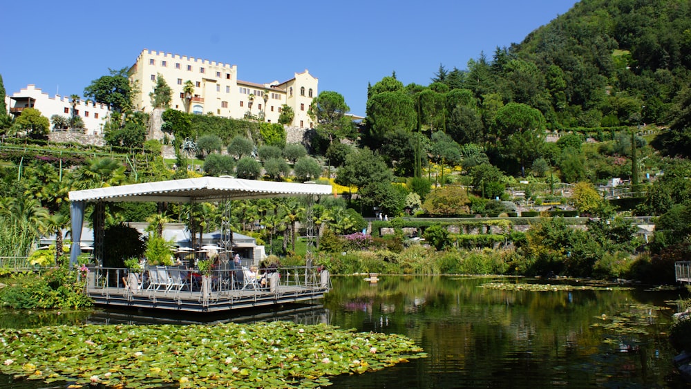 a house on a hill with a lake in front of it