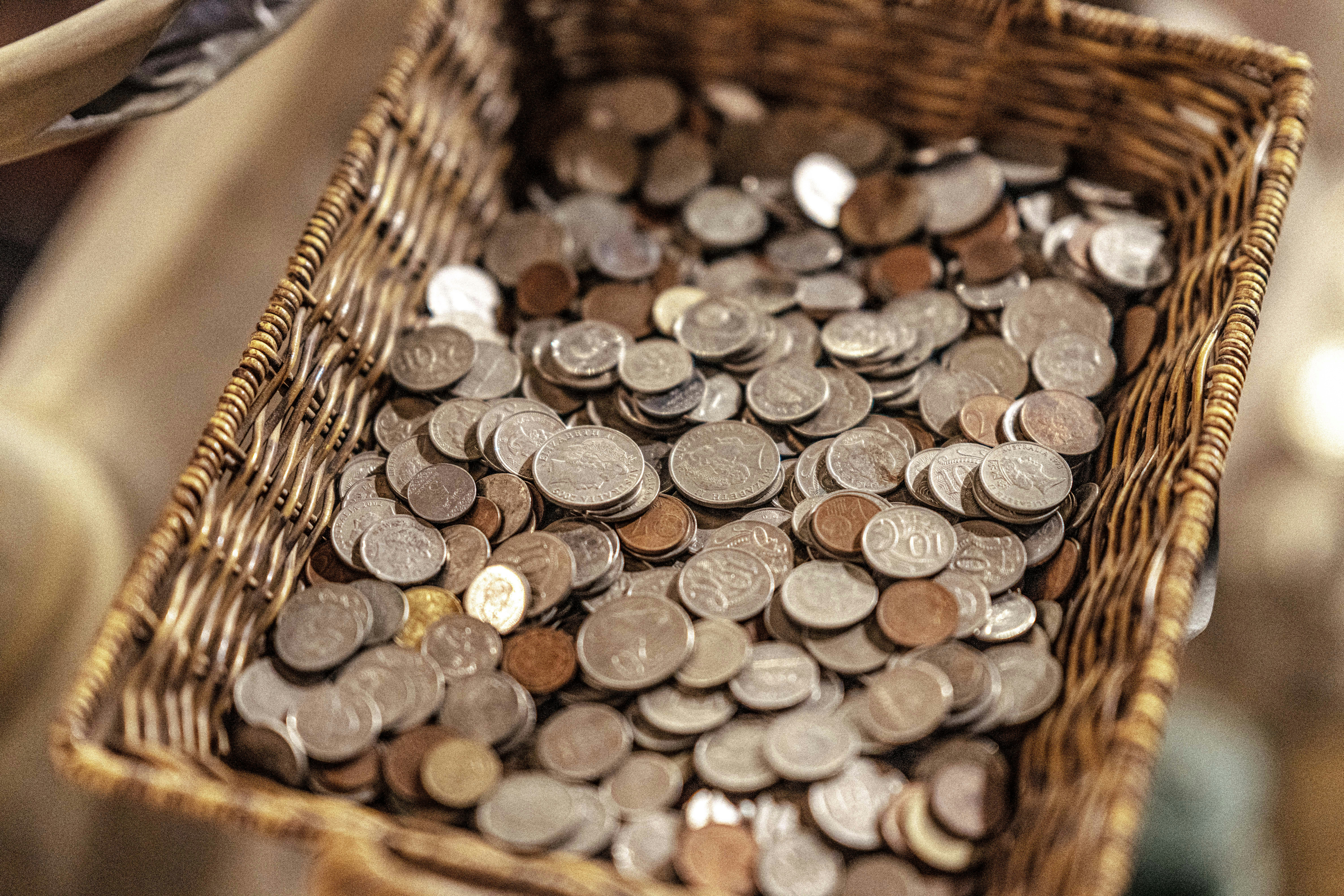 Wicker basket filled with loose coins