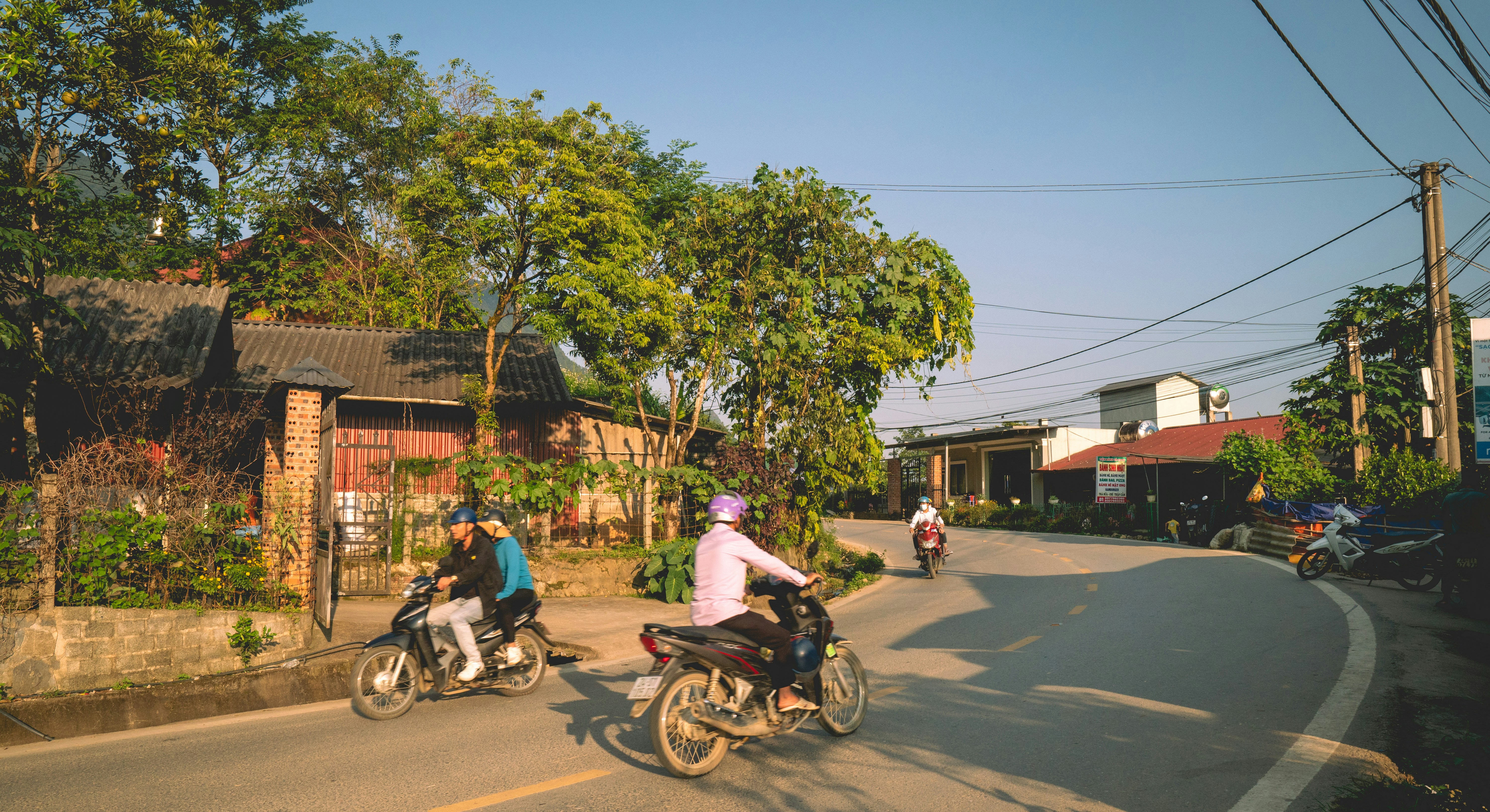 a group of people riding motorcycles down a street