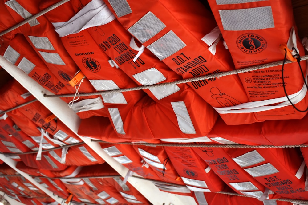 a bunch of life vests hanging on a wall