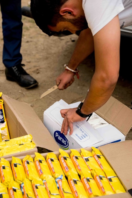Close-up of a customer happily unboxing a package from zippy ration at home.