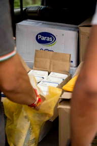 a man is unloading a box of pizza