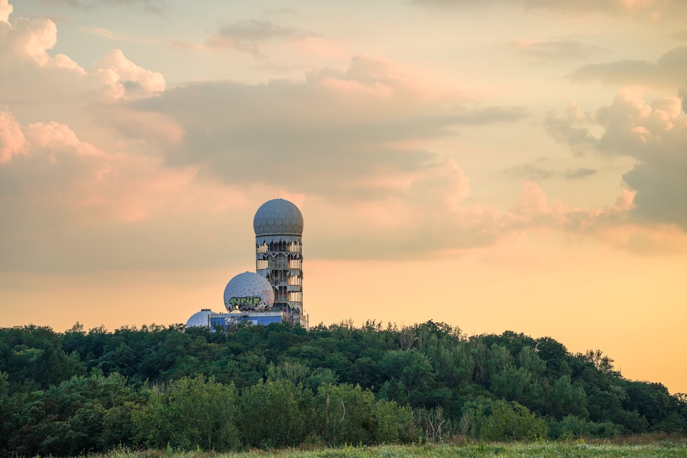 a large radio tower sitting on top of a lush green hillside