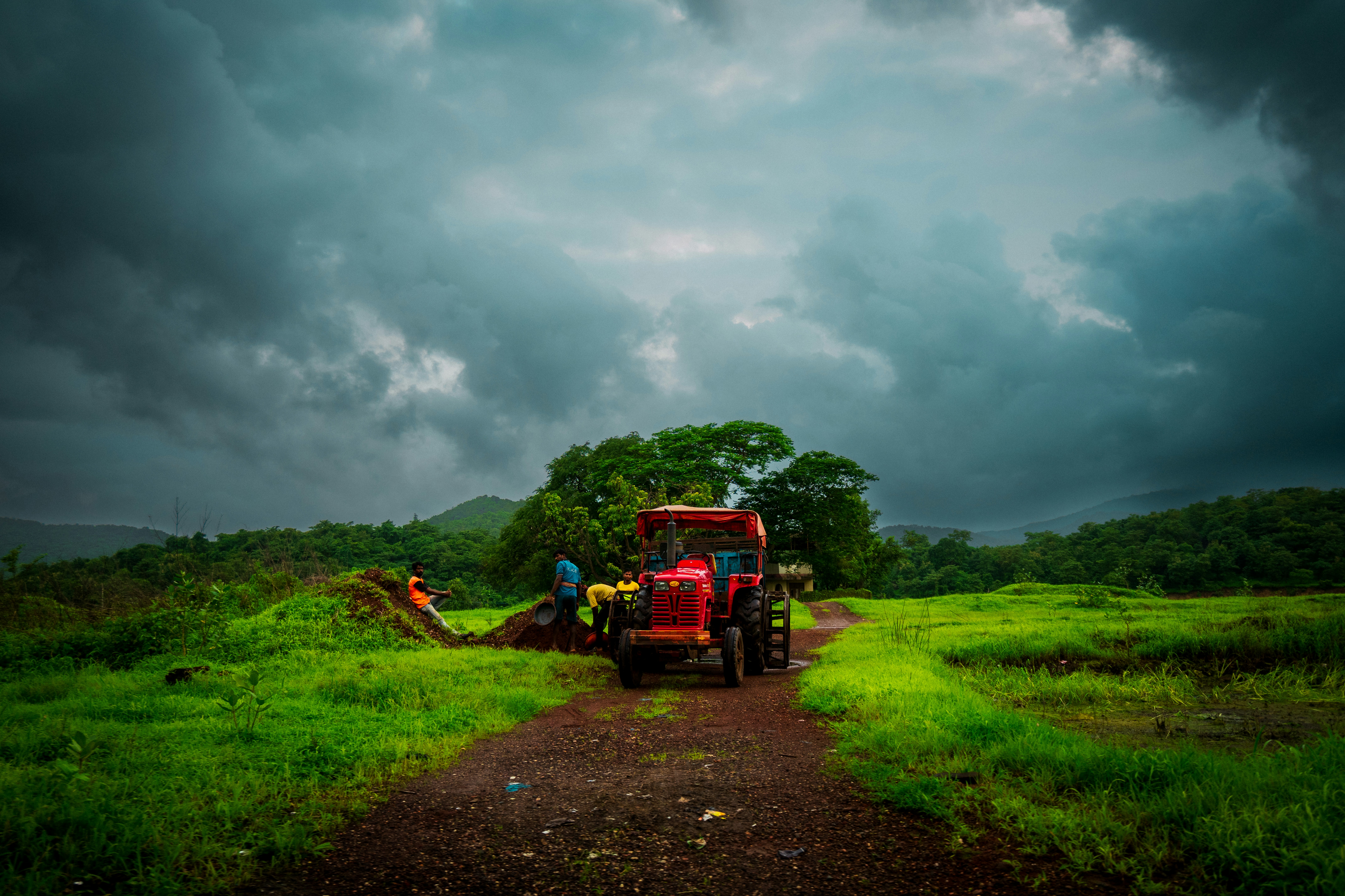 a tractor is parked on a dirt road