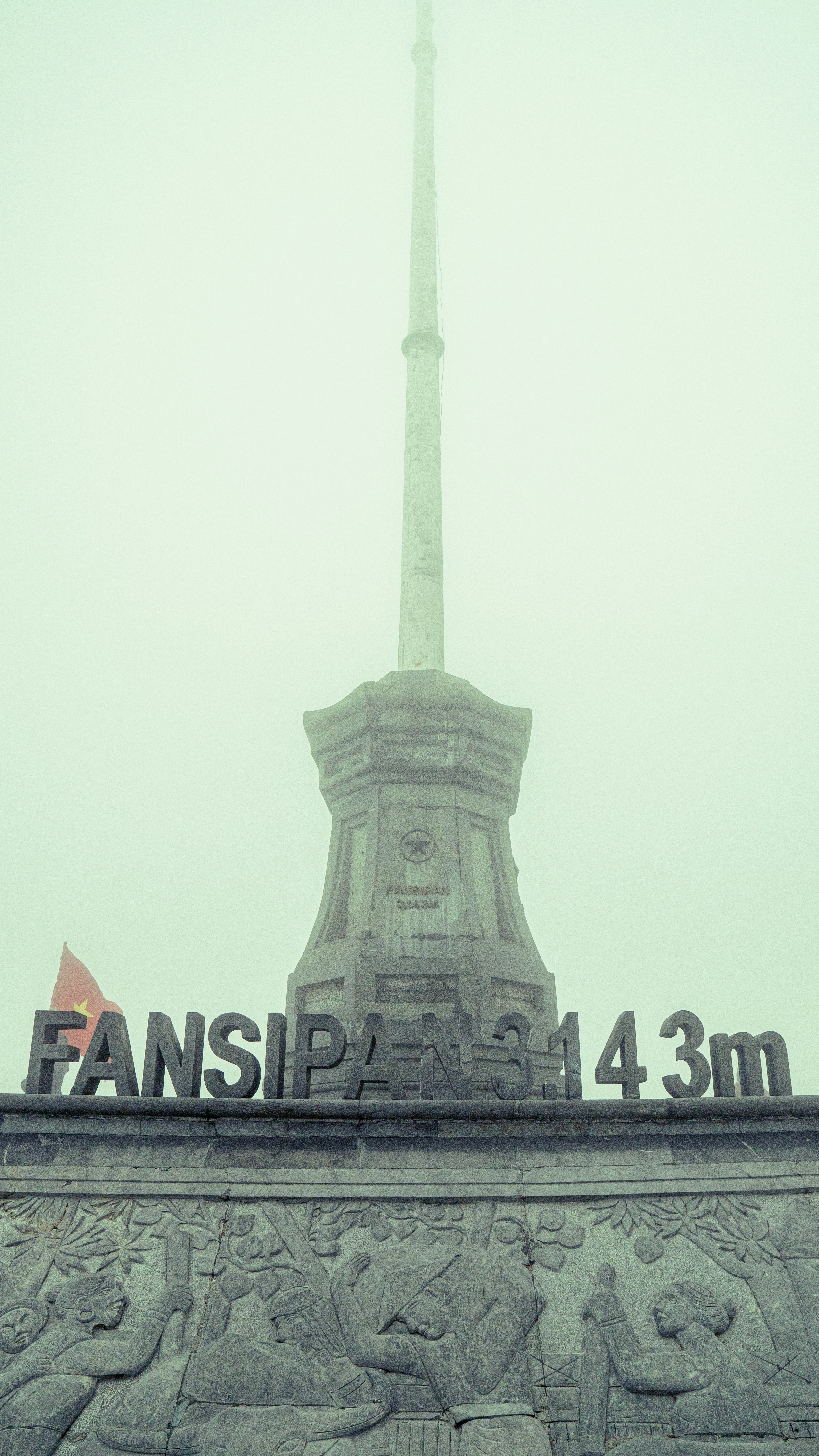 a monument with a flag on top of it