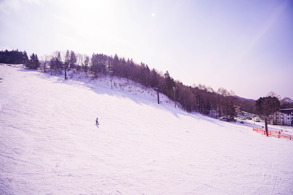 a person riding skis down a snow covered slope