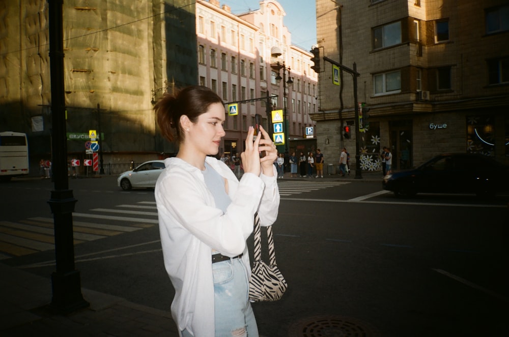 a woman taking a picture of herself with her cell phone