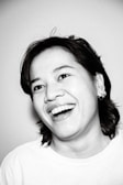 A professional portrait of a smiling individual in casual attire.