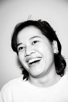 A vibrant portrait of a smiling individual outdoors.