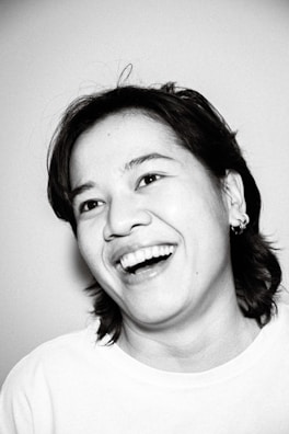 A professional portrait of a smiling individual in casual attire.
