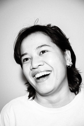 Black and white portrait capturing a joyful candid smile.