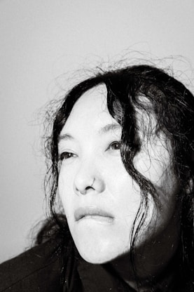 a black and white photo of a woman with wet hair