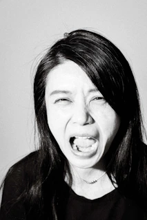Black and white portrait of Jaiden lost in musical storytelling, eyes closed, expressing emotion