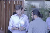 A deacon engaged in conversation with a community member outdoors.
