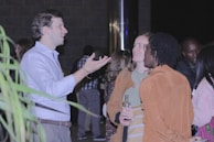 Guests enjoying drinks and conversations at a social gathering.