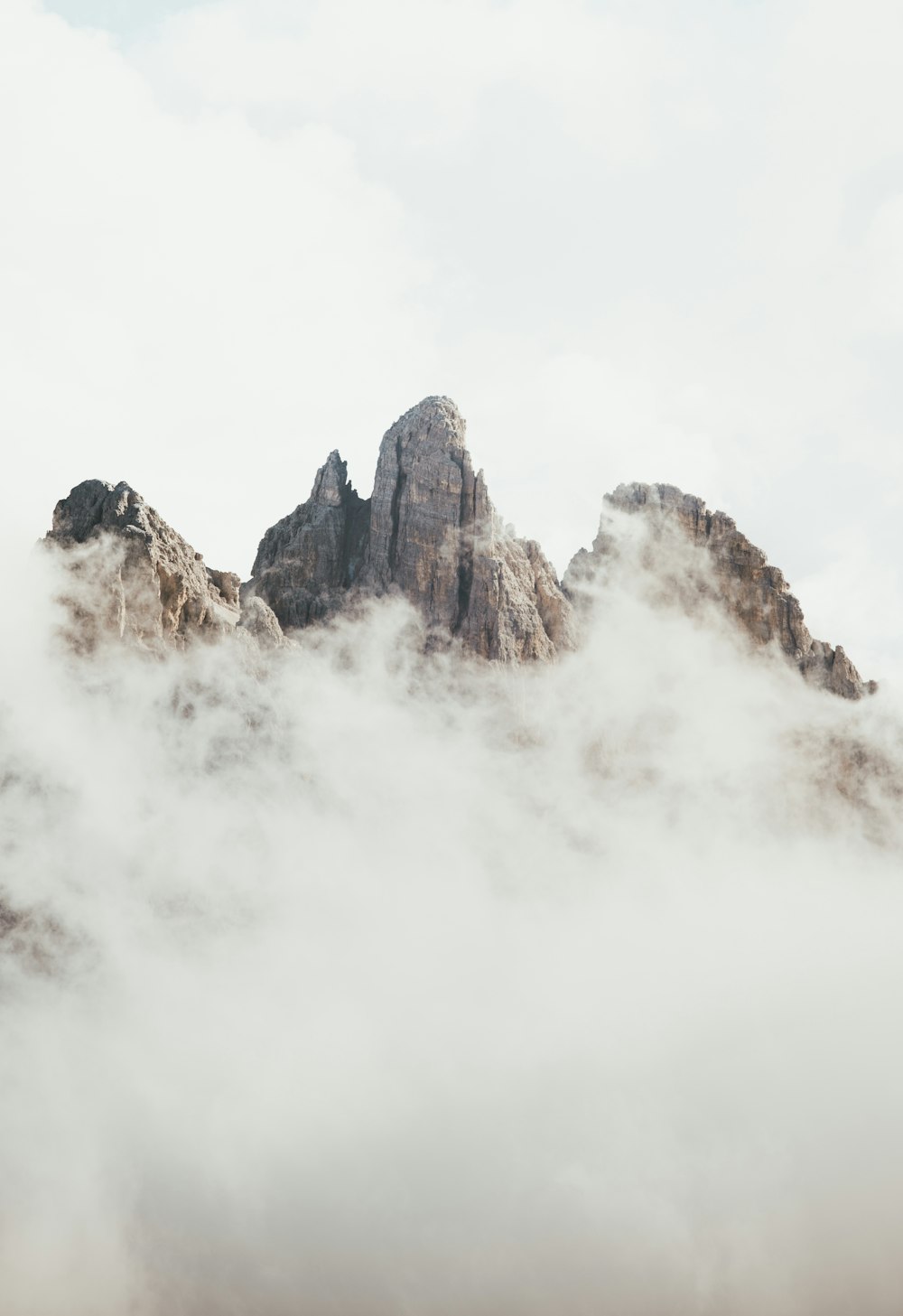 a mountain covered in clouds with a sky background