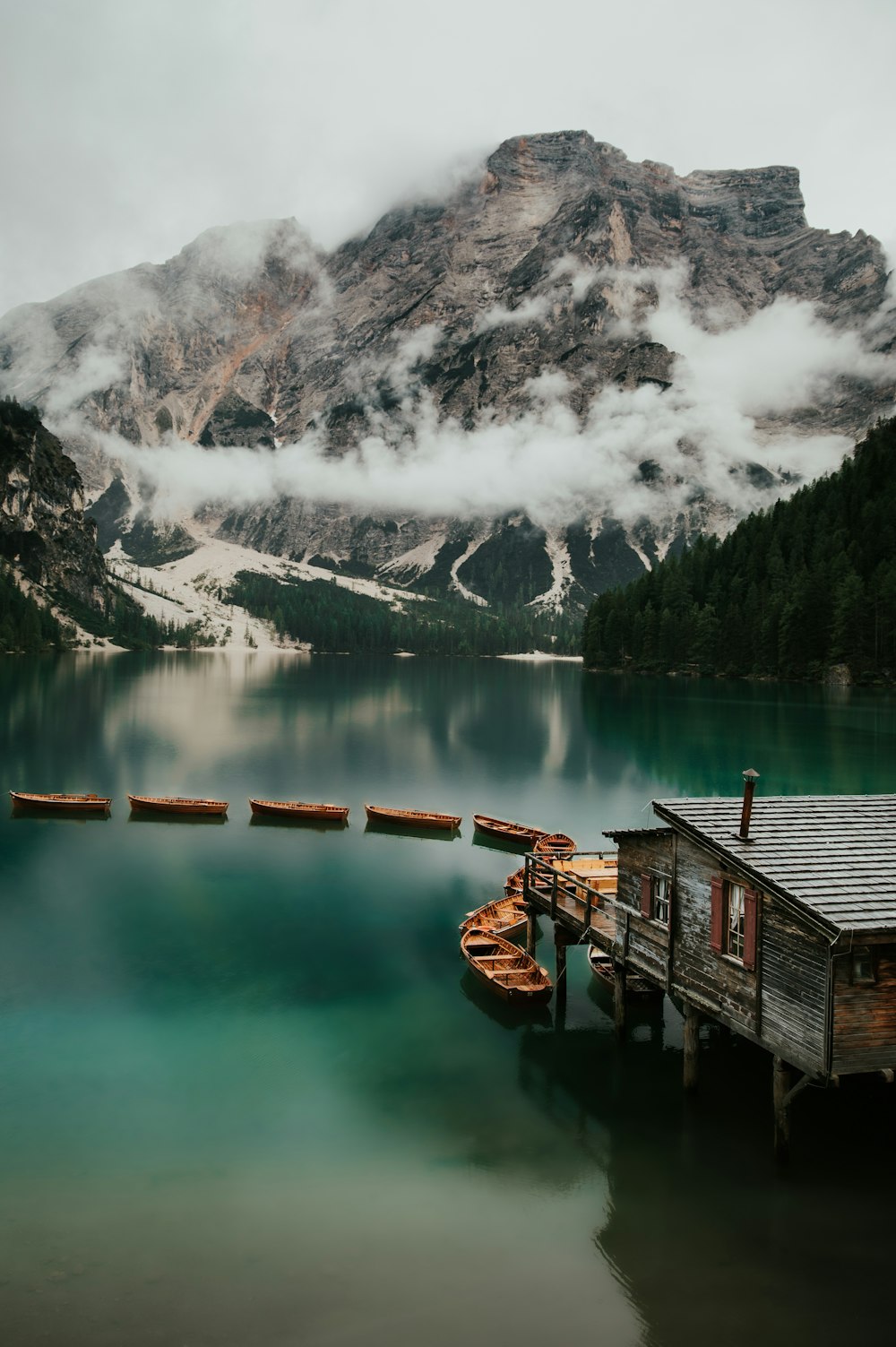 a boat dock in a lake with a mountain in the background