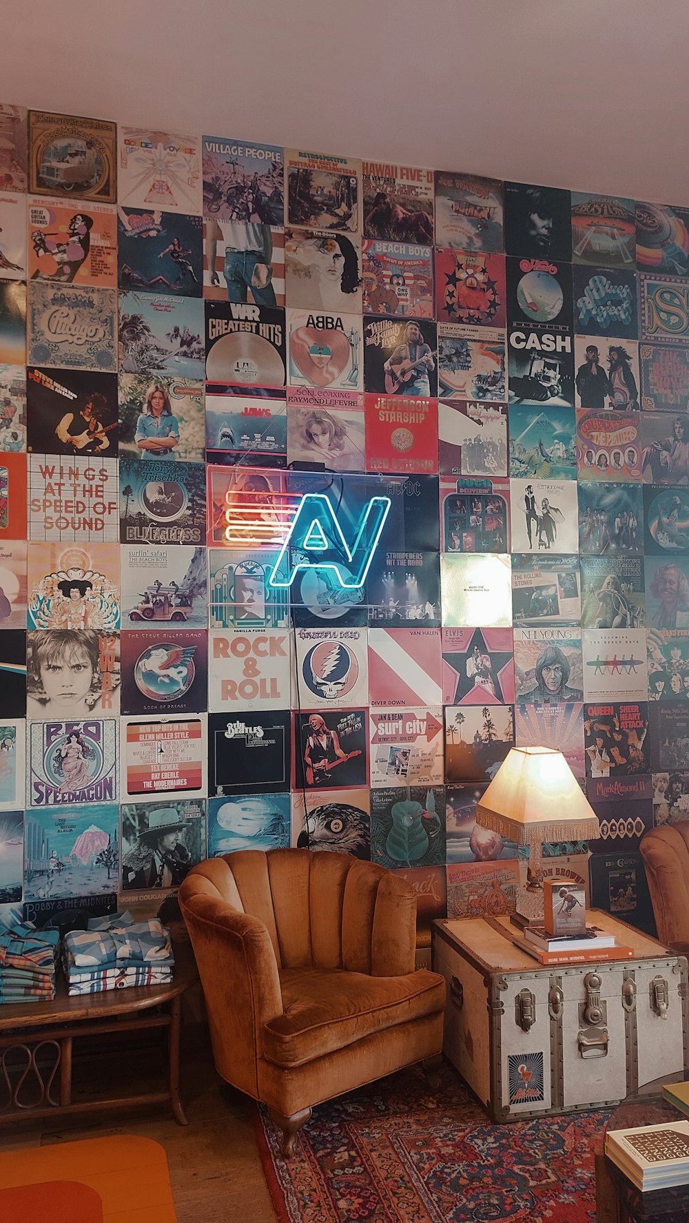 a living room with a wall covered in posters