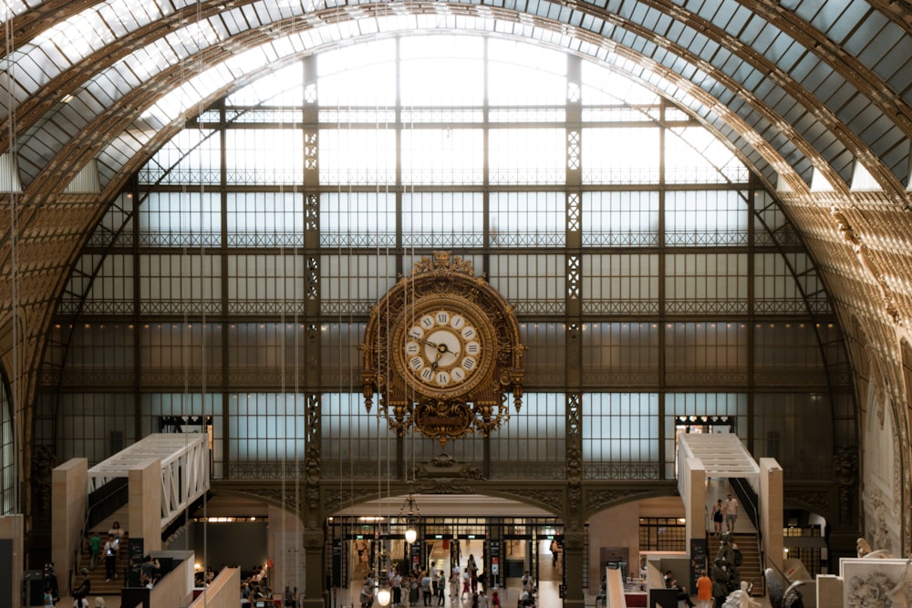 a large clock hanging from the ceiling of a building