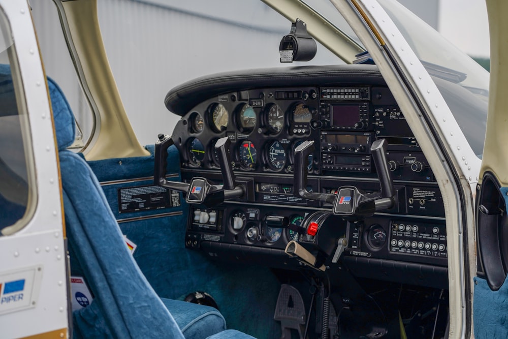 the cockpit of a small airplane with a blue seat