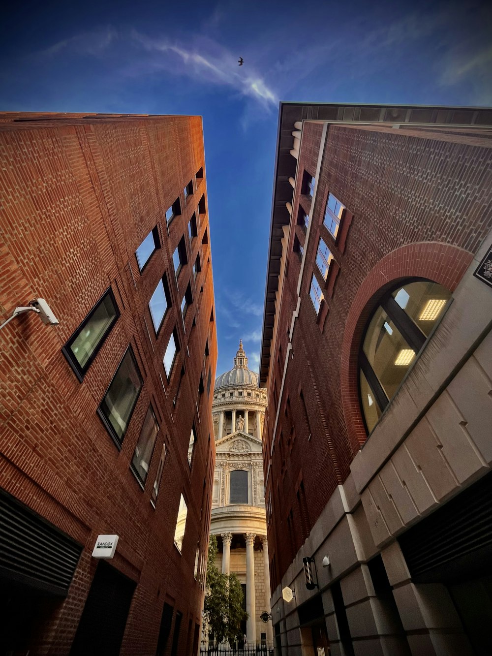 a tall building with a clock tower in the background