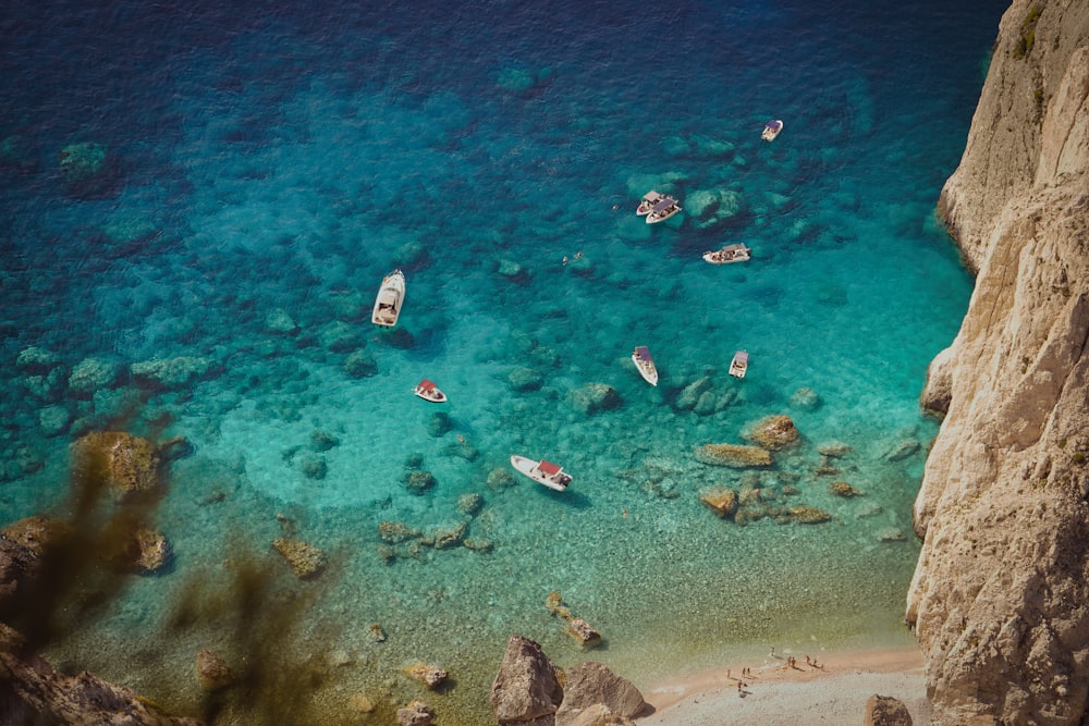 a group of boats floating on top of a body of water