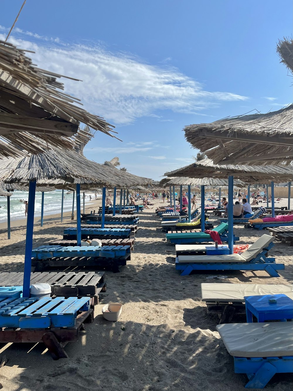a sandy beach covered in lots of umbrellas and lounge chairs
