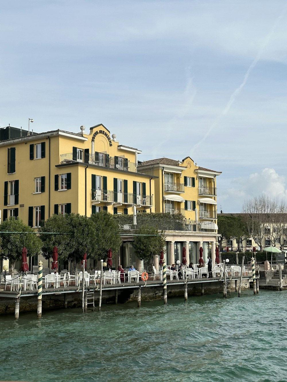 a large yellow building next to a body of water