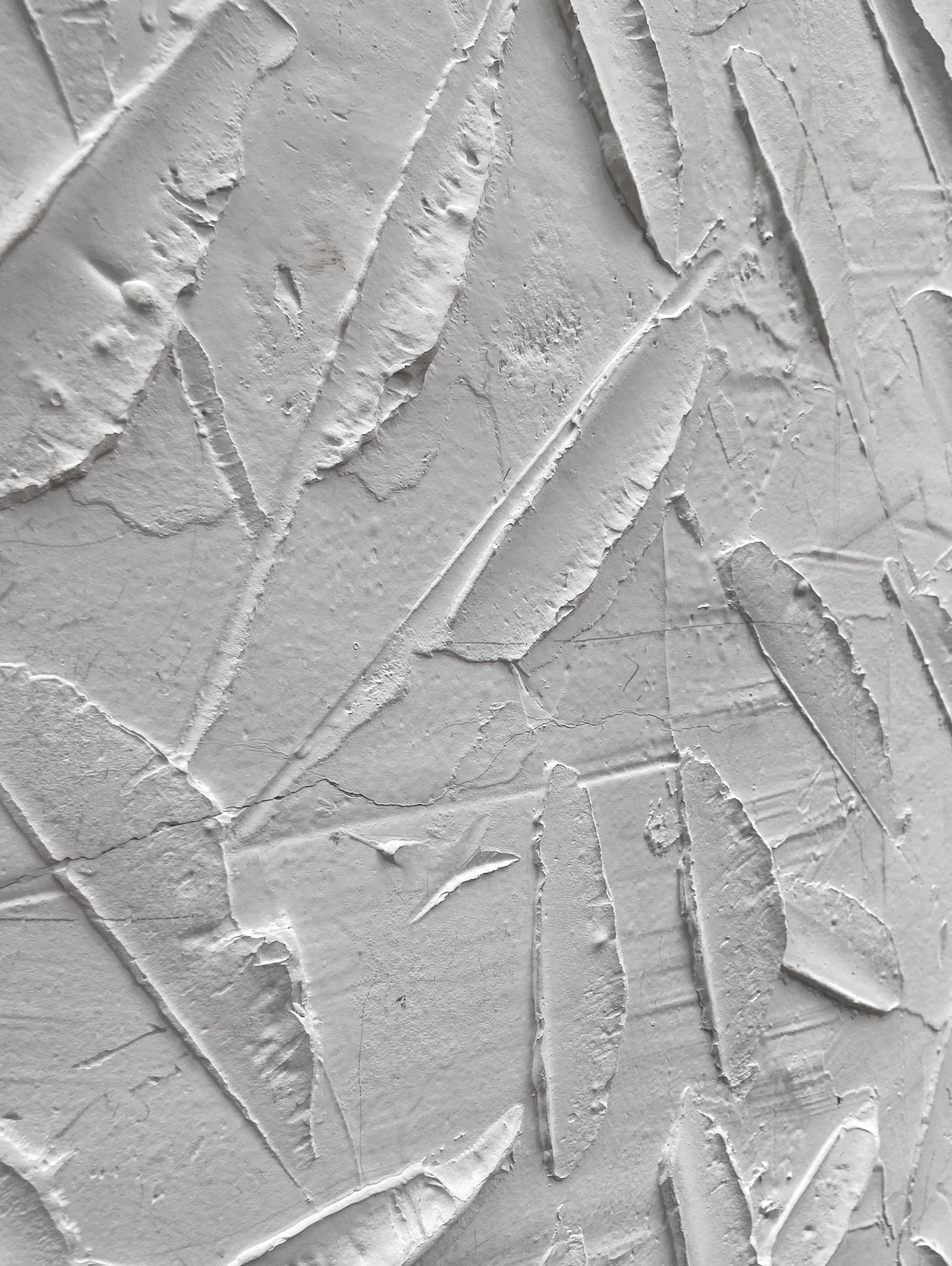a close up of a wall with white paint